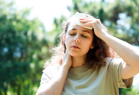 mujer sintiéndose mal secándose el sudor